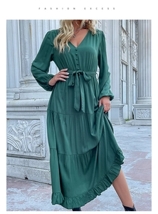 Detail of V-neck dark green maxi dress with buttons, waist tie and ruffled hemline