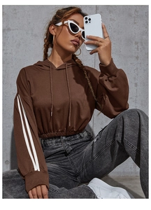 Detail of cropped chocolate brown hoodie with double white stripes on the sleeves