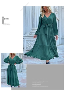 Detail of dark green satin dress featuring a V-neckline with buttons and tiered ruffles