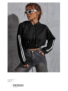 Detail view of cropped black hoodie with dual white sleeve stripes and drawstring hem