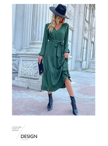 Detailed view of the dark green tiered dress with pleated ruffles and buttoned V-neck