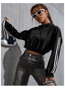 Detail of black cropped hoodie featuring white double stripes on sleeves and ribbed cuffs