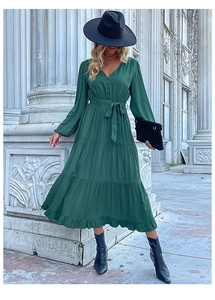 Detail view of dark green tiered maxi dress with V-neckline and waist tie detail