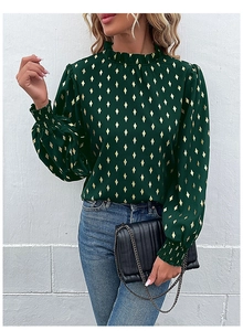 Detail of dark green blouse with gold diamond patterns, ruffled high neck, and puffy sleeves