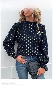 Detail of navy blue women blouse with gold diamond print, stand collar and lantern sleeves