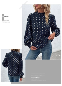 Detailed view of women's navy gold foil blouse with ruffle neck and puff sleeves