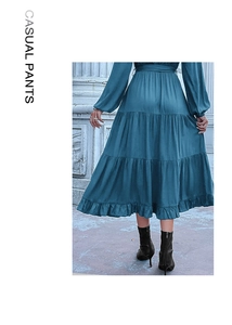 Detail view of the elegant peacock blue tiered ruffled dress with a flowing layered skirt