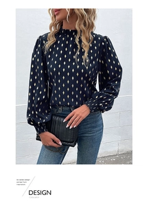 Detail of ruffled high neck and gold diamond print on a navy blue long sleeve blouse