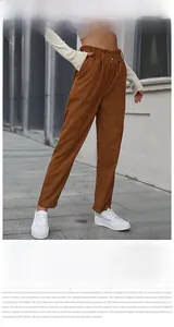 Detail of high waist elastic corduroy pants with button decor in casual straight fit