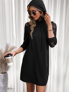 Detail of elegant black hooded mini dress featuring intricate lace crochet on long sleeves