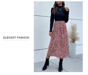 Detail of elegant black knit top and high-waist red zebra print A-line maxi skirt