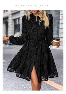 Detail of black long sleeve lace mini dress with textured 3D floral fabric and belt