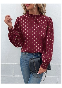 Detail view of burgundy chiffon shirt featuring gold diamond prints and ruffled high neck