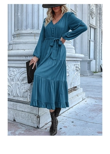 Detail of V-neckline and waist tie on a dark blue tiered long sleeve dress