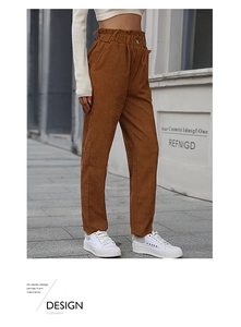 Close-up of women's brown corduroy pants featuring high waist and paperbag waist details