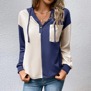 Detail of waffle knit fabric on navy and cream color block hoodie with buttons