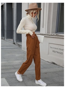 Detail of high waisted brown corduroy straight leg pants with paperbag waist and button