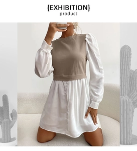 Détail de la robe contrastée avec manches bouffantes et superposition de gilet beige