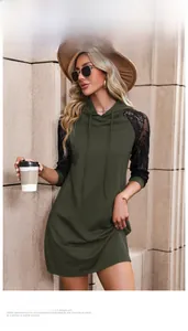 Detail of dark green hooded dress showing black lace patchwork sleeves and drawstrings