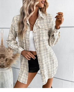 Detail of tweed checkered coat showing textured fabric and elegant pearl buttons