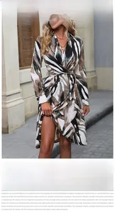 Detail of V-neck long sleeve dress featuring abstract print and twisted waist design