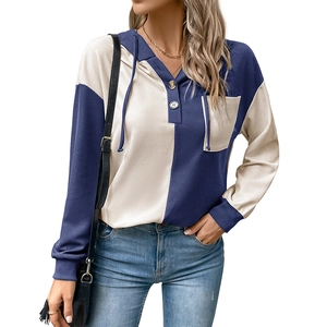 Detail of waffle knit fabric and color block design on women's hooded sweatshirt