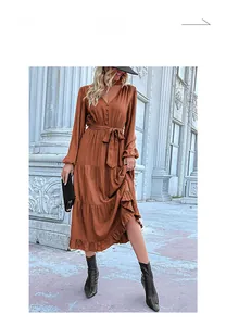 Detail of V-neck tiered midi dress in burnt orange with drawstring waist and long sleeves