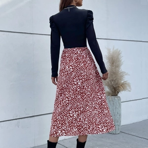 Women's chic puff sleeve dress featuring a black turtleneck top and red wavy print skirt