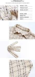 Detailed close-up of tweed coat collar with pearl button and textured plaid pattern