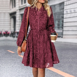 Close-up of wine red lace dress with textured floral patterns and buttoned drawstring waist