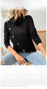 Detail view of black ribbed knit top with stylish white buttons on the cowl neckline