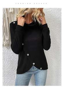 Detail of black ribbed knit top featuring asymmetrical button hem and cowl neck collar
