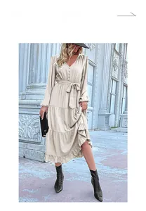 Detail showing the deep V-neckline and tie-waist on this beige long-sleeve tiered dress