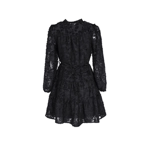 Close-up of black lace tiered dress featuring intricate jacquard texture and high collar