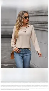 Detailed close-up of beige textured knit sweatshirt with unique asymmetric buttoned collar