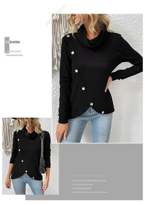 Detail of black long sleeve knit top featuring decorative buttons and irregular hemline