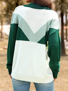 Detailed back view of a color-block knit sweater with geometric V-pattern and ribbed cuffs