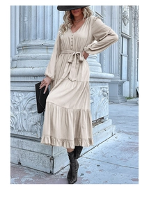 Detail of elegant V-neckline and buttoned bodice on this tiered beige maxi dress