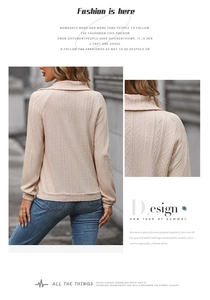 Detail shot of the textured jacquard fabric and stylish polo collar on a beige sweatshirt