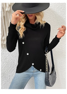Detail of black ribbed knit top featuring asymmetrical crossover hem and white buttons