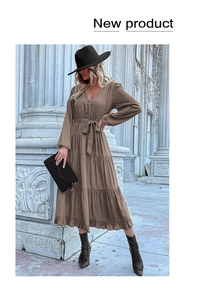 Detail of V-neck brown long-sleeve tiered dress with waist tie and button accents