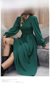 Detail of smocking texture and lantern sleeves on this dark green A-line midi dress