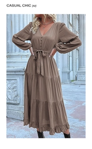 Detail of coffee V-neck tiered maxi dress featuring buttoned front and waist tie belt