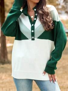 Detail of color block knit sweater featuring a buttoned polo collar and ribbed cuffs