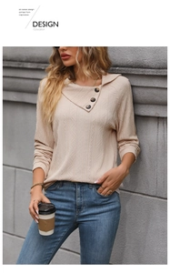 Detail of waffle textured beige sweatshirt with asymmetric collar and decorative buttons