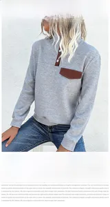 Detail of diamond quilted texture and contrast brown pocket on long sleeve sweatshirt