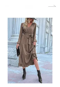 Detail of V-neck long sleeve tiered brown dress with button decor and waist tie