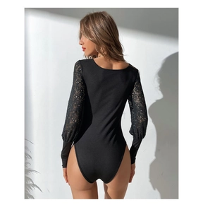 Close-up of women's black bodysuit featuring intricate lace hollow out sleeves and ribbed fabric