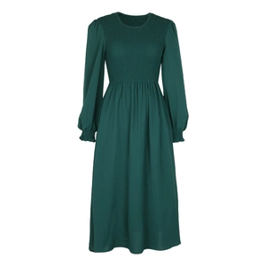 Detail of smocking texture on dark green long sleeve dress with puff sleeves