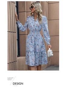 Detail of light blue floral dress with smocked waist, V-neck, and ruffled hem finish